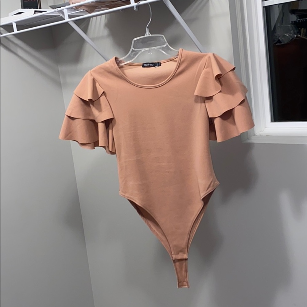 Pink bodysuit with ruffles on arm